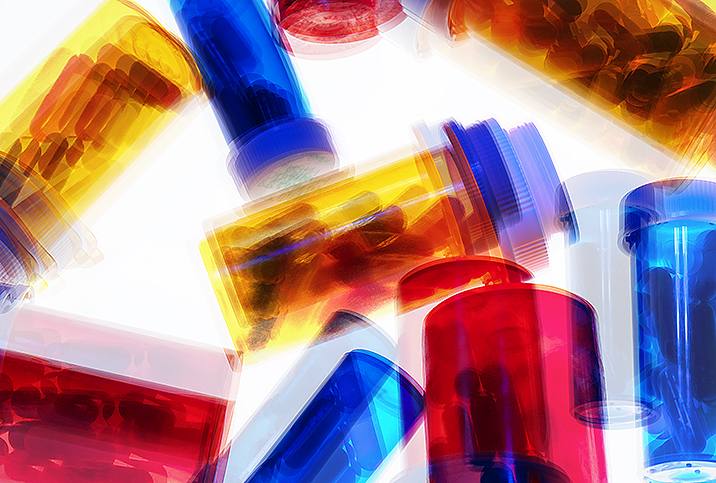 multicolored pill bottles looking blurry as if they are shaking