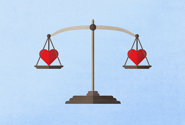 A scale weighs two red hearts, one on each side. 