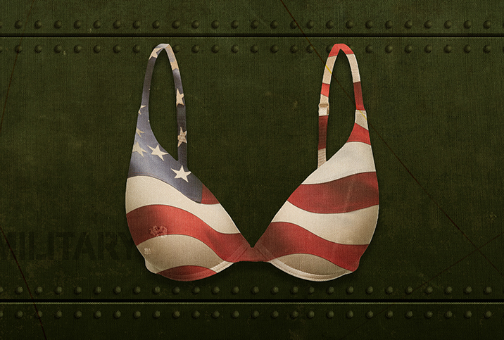 A bra with an American flag pattern for fabric is against an army green metal wall.