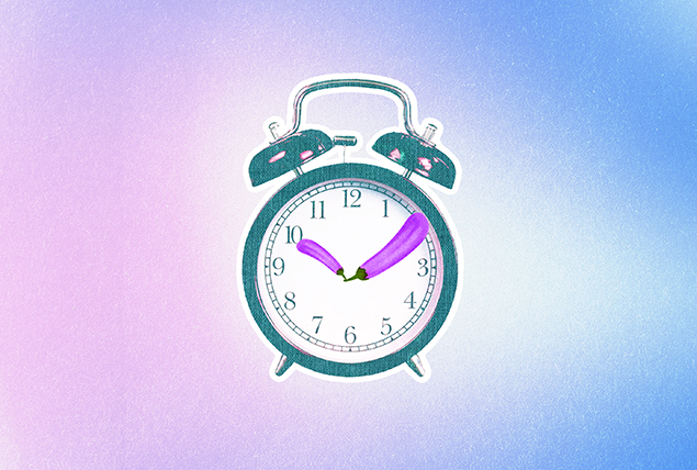 The arms of an alarm clock are made of purple eggplants.