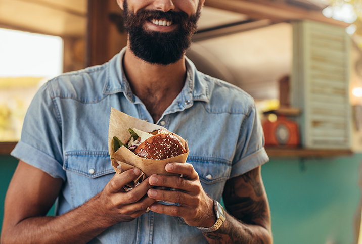 A-bearded-man-holds-a-burger