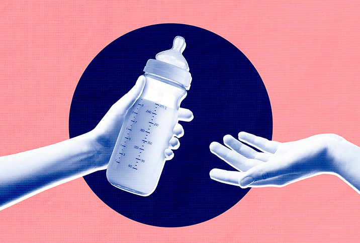 One arm is reaching out to hand a bottle of breast milk to another.