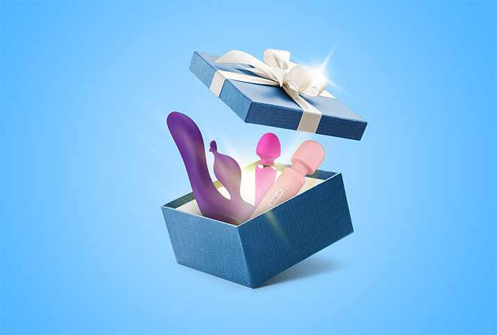 Multiple vibrators are inside a blue gift box that is popping open. 