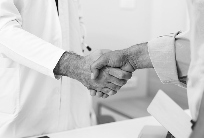 A man shakes hands with a doctor.