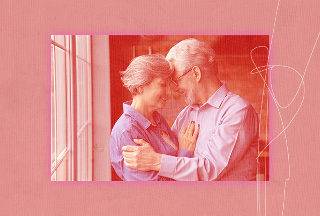 A elder couple holds each other smiling.